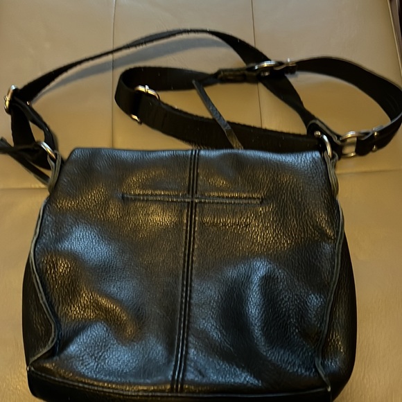 Black leather purse, shoulder strap is canvas. Front decorative metal design - Picture 2 of 3